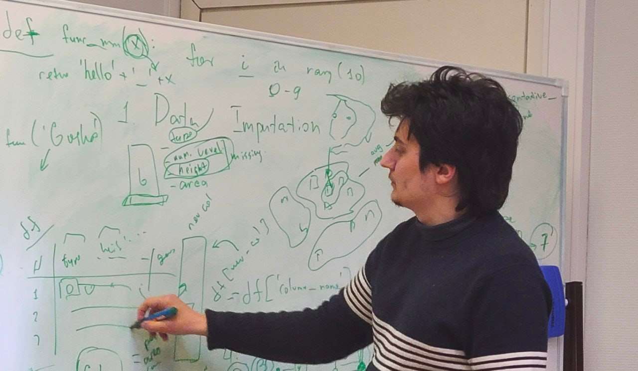 George Kontsevik teaching at a whiteboard with Python and data imputation examples